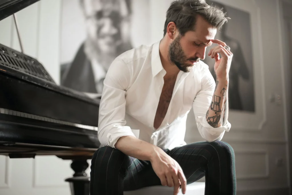 Prise de décision : photo d'un pianiste tatoué en pleine réflexion sur sa vie
